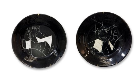 GARELLI Due piatti smaltati in nero con decoro graffito a figure femminili....