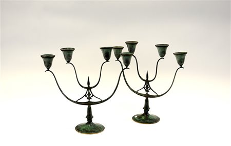 Coppia di candelabri di gusto Novecentoin fusione di bronzo patinato verde....