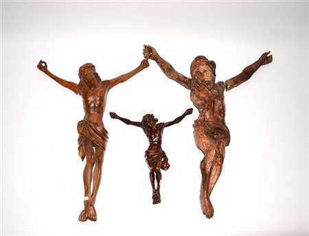 Lotto di tre sculture in legno intagliato raffiguranti Cristo crocifisso,...