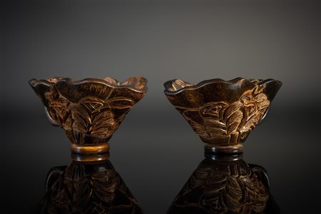 Arte Cinese  A pair of rhino horn libation cups carved with flowers China, Qing dynasty, 19th century .