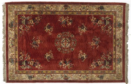 Arte Cinese  A Chinese rug decorated with flowers over red ground China, 20th century .
