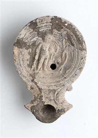 Roman Oil Lamp with Winged Eros, 1st - 2nd century AD; height cm 3, length cm 11