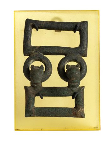 Etruscan Bronze Belt-Buckle, 6th - 5th century BC; height cm 12, length cm 8; plexiglass stand cm 15 x 10,5