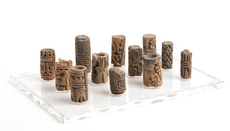 Collection of twelve terracotta cylindrical pintaderas, Colombia and Ecuador, Tumaco-La Tolita Culture, ca. 4th century BC - 5th century AD; height max cm 7,7 - min cm 5, diam.max cm 3,7 - min cm 2,1, plexiglass base cm 23 x 25,2.