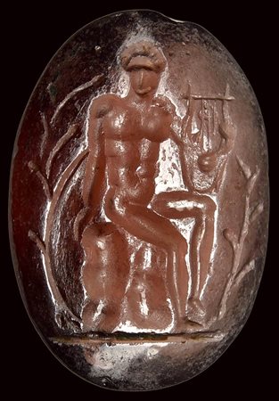 A roman late republican garnet intaglio. Apollo citharedus. 