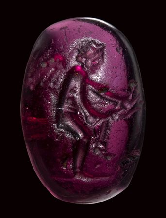 A roman republican garnet intaglio. Eros with a bow. 