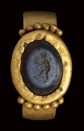 A roman nicolo intaglio set in an ancient gold ring. Faun.