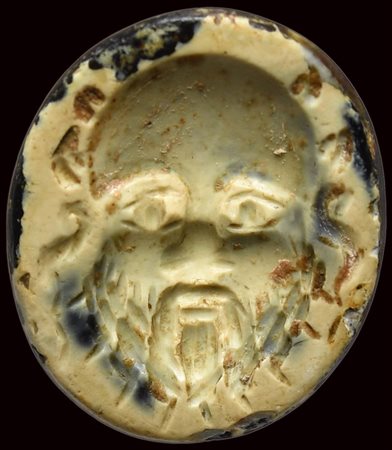 A roman burnt agate intaglio. Mask of Silenus. 