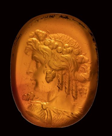 A very fine late hellenistic carnelian intaglio. Bust of Bacchante. 