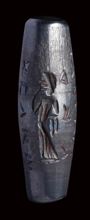 A roman hematite magical fusiform amulet. Feminine figure with inscriptions. 
