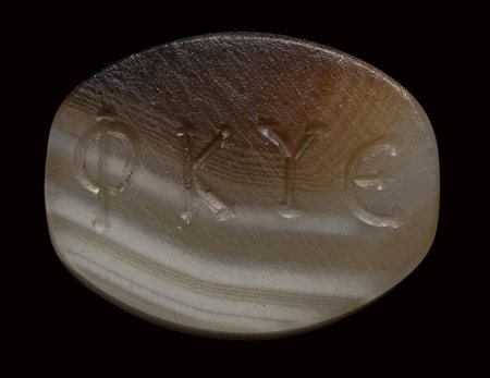 A graeco-roman agate engraved seal. Ear of corn and inscriptions.