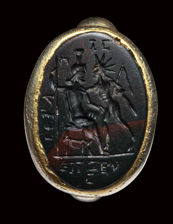 A roman magical green and red jasper intaglio set in an ancient electrum ring. Serapis and Helios with magical inscriptions. 