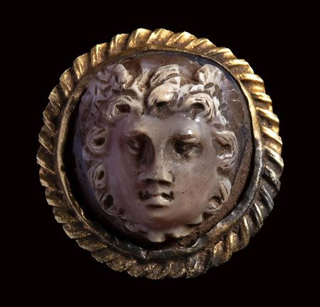 A roman agate cameo mounted in an ancient gold brooch. Medusa mask. 