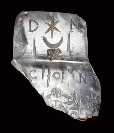 A late roman rock crystal fragment of a bulla. Constantinian inscriptions with emblema.