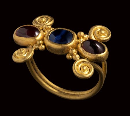 A late roman gold ring set with a shappire and two garnets.