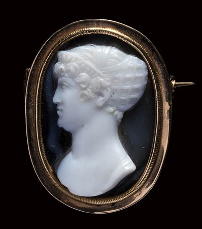 A late Georgian gold brooch set with an onyx cameo portrait by Berini. Bust of a noblewoman. 