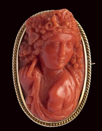 A fine Victorian coral cameo set in a gold brooch. Bacchante. 