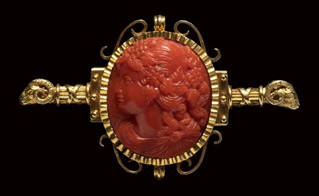 A  fine Victorian coral cameo set in a gold brooch. Bacchante. 