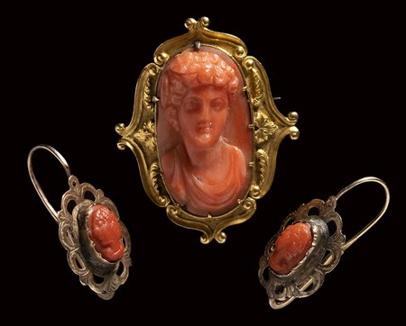 A Victorian red coral cameo set in a gold brooch with two small coral cameo set in earrings. 