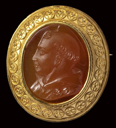 A carnelian cameo mounted in a gold brooch. Bust of a Saint Anthony of Padua. 