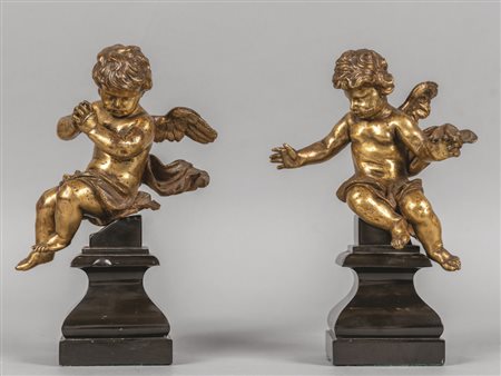 Putti, coppia di sculture in bronzo dorato 
