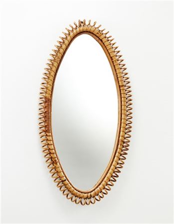 Specchio da parete di forma elissoidale con cornice in giunco e malacca. Italia