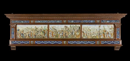 MANIFATTURA MOLARONI DEL XX SECOLO  - Pannello in maiolica dipinta con i Trionfi di Cesare dal modello di Andrea Mantegna e cornice in legno scolpito.