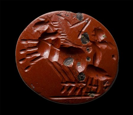 A roman red jasper intaglio. Winged eros on a biga.