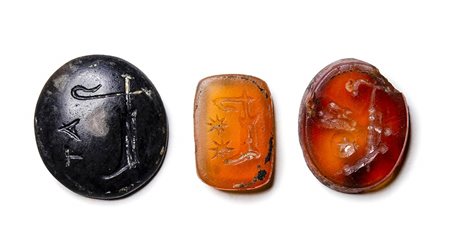 A group of 3 late republican agate and carnelian intaglio. Apotropaic symbols. 