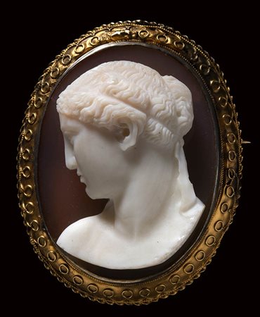 A two-layered agate cameo mounted on a gold brooch. Female bust. 