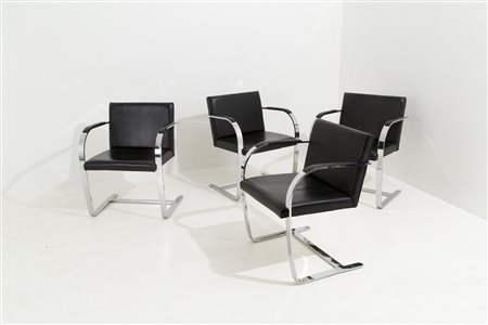 Four armchairs in steel and black leather. Italy. '60s