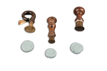 Lotto composto da tre sigilli, di cui due in bronzo con manico in legno ed uno con manico in corno, con stemmi nobiliari, secoli XVIII - XIX