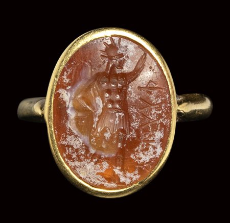 A roman burnt carnelian intaglio set in a gold ring. Sol Invictus. <br><br>2nd - 3rd century A.D.