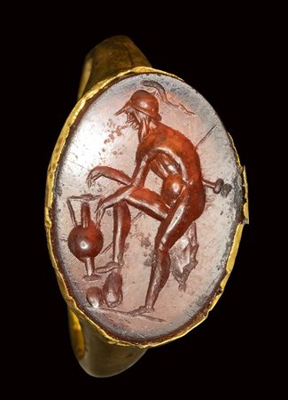 A roman carnelian intaglio set in a gold ring. Heraclides attempting a draw. 1st century A.D.