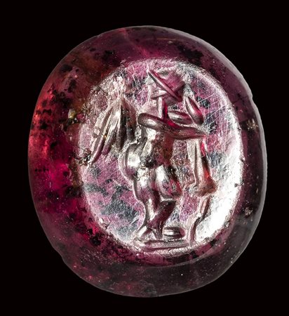 A roman garnet intaglio. Eros with a torch.<br><br>3rd century A.D.