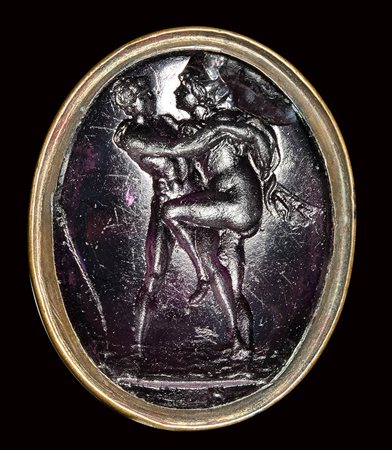 A dark purple glass impression set in gilted metal fob seal. Hermaphrodite and Salmace. 18th - 19th century. 