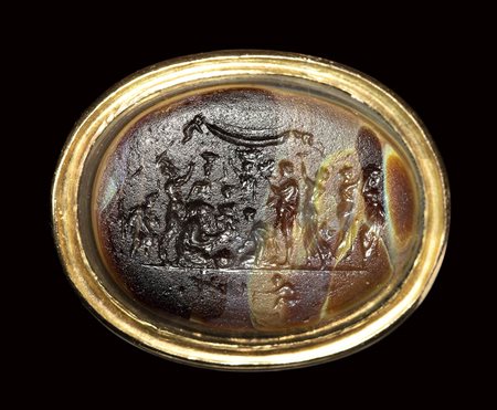 A polychrome glass paste impression set in a gold ring.  The "Michelangelo seal". 18th - 19th century.