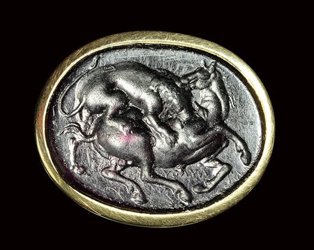 A dark purple glass impression set in a signet gold ring. Lion with an horse. <br><br>19th century.