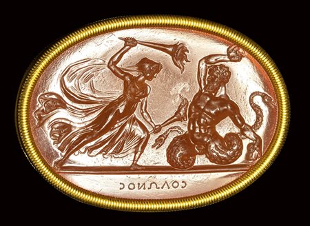 A fine neoclassical Poniatowski  carnelian intaglio signed Solonos, set in a gold frame. Diana Hecate killing a Titan. 19th century. 