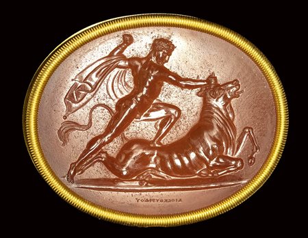 A fine neoclassical Poniatowski  carnelian intaglio signed Dioskourides, set in a gold frame. Milo killing the bull. 19th century.