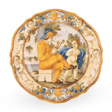 Manifattura castellana del XVIII secolo ( - ) 
Piatto in maiolica decorato al cavetto con scena istoriata di fumatore di pipa e putto.  
 Ø cm 25