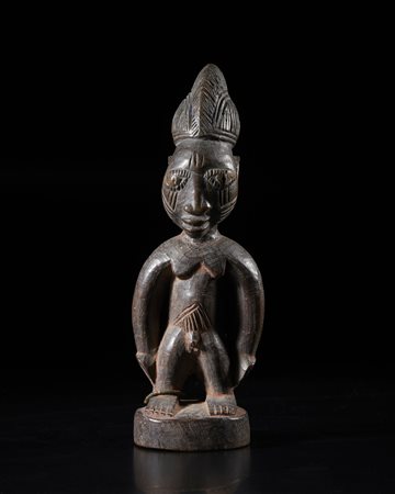  Arte africana - Nigeria, Yoruba. 
Figura di Ibeji. 
Legno, perline, tracce di pigmenti. 
Inizi del XX sec. .