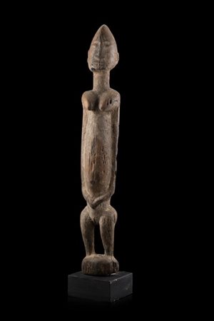 Arte africana. Figura femminile in legno intagliato (h. cm 52,5) poggiante su b