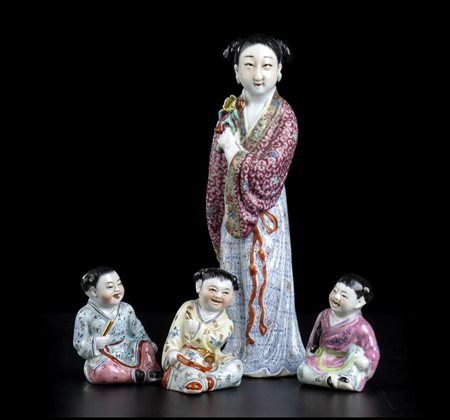 FIGURA FEMMINILE E TRE BAMBINI IN PORCELLANA CON DECORO A SMALTI POLICROMI
Cina, XX secolo