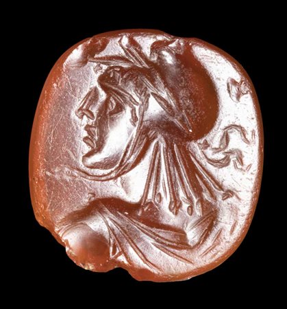 A PTOLEMAIC CARNELIAN INTAGLIO. BUST OF YOUTH WITH PHRYGIAN CAP. 