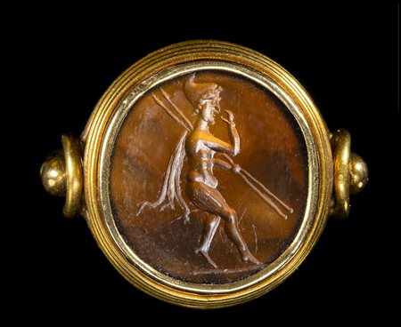 A FINE LATE ROMAN REPUBLICAN SARD INTAGLIO SET IN A GOLD RING. ATTIS WITH TWO SPEARS. 