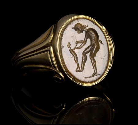 A ROMAN CHALCEDONY INTAGLIO SET IN A GOLD RING. SATYR PLAYING WITH A CHILD. 