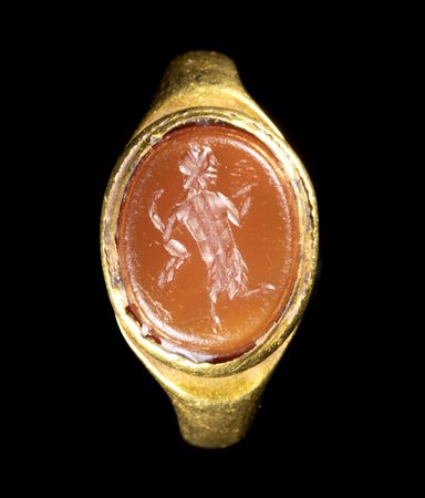 A ROMAN CARNELIAN INTAGLIO SET IN AN ANCIENT GOLD RING. SATYR. 