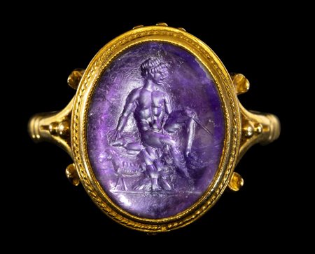 A ROMAN AMETHYST INTAGLIO SET IN A GEORGIAN GOLD RING. SEATED MERCURY. 
