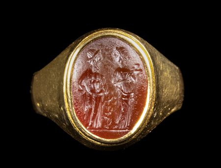 A ROMAN CARNELIAN INTAGLIO SET IN A GOLD RING. ASCLEPIUS AND HYGIEIA